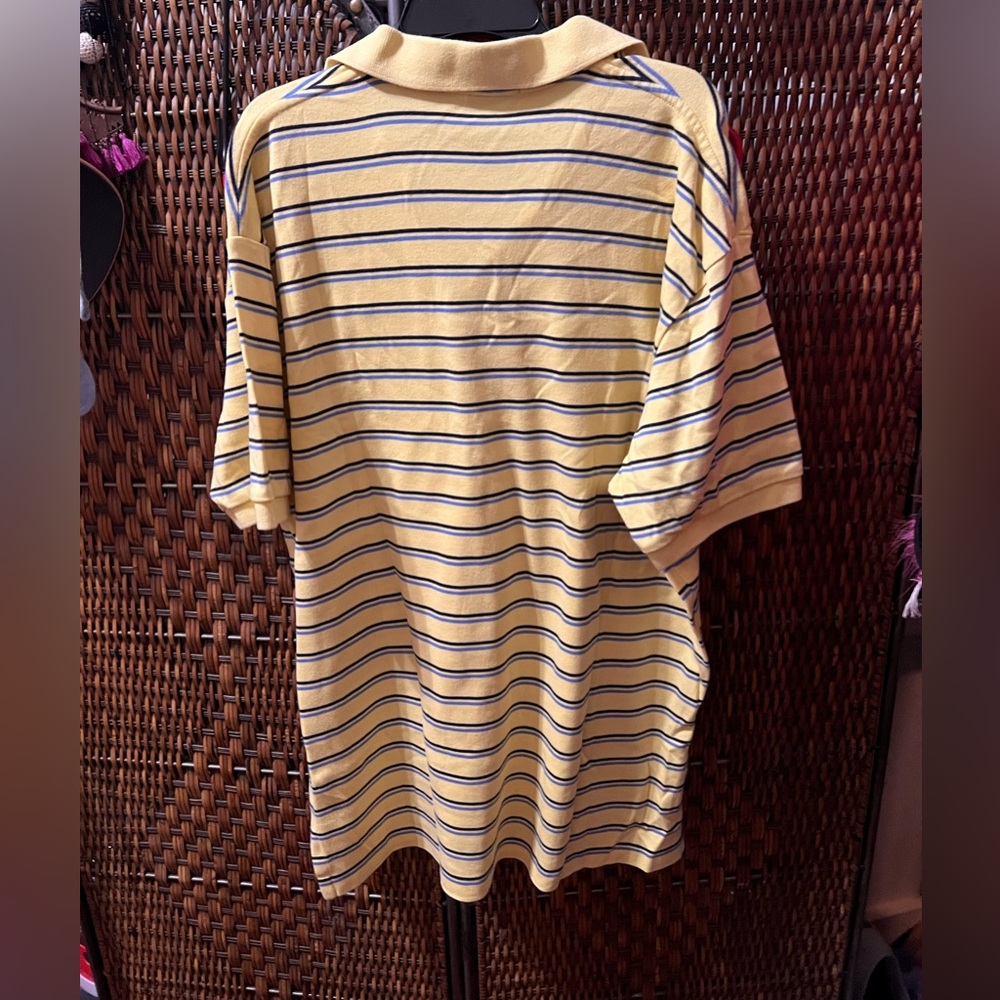 This is a yellow polo shirt in good condition.